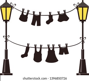 Black drying clothes hanging on a washing rope between two black and yellow street lights. Summer vector illustration. Socks, trousers, skirt and a dress on a rope with pins