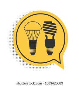 Black Economical LED illuminated lightbulb and fluorescent light bulb icon isolated on white background. Save energy lamp. Yellow speech bubble symbol. Vector.
