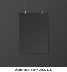 Black empty paper with clips on the wall