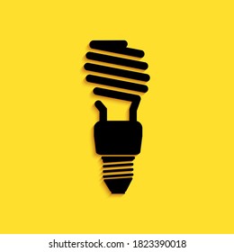 Black Energy saving light bulb icon isolated on yellow background. Long shadow style. Vector.