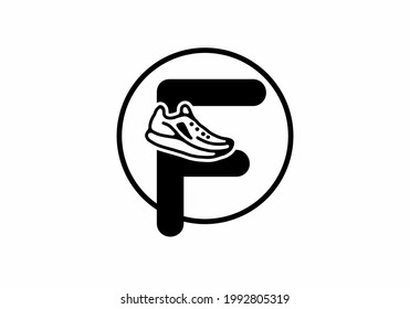 Black F initial letter with shoes in circle design