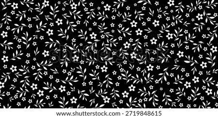 black fabric with white floral patterns, featuring small daisies or cosmos flowers, adorned with leaf motifs, creates, sweet look. White floral and leaf pattern on a black background, seamless design.