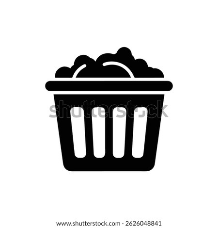 Black Filled Icon of a Laundry Basket with Clothes Inside