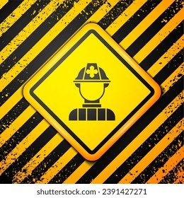 Black Firefighter icon isolated on yellow background. Warning sign. Vector