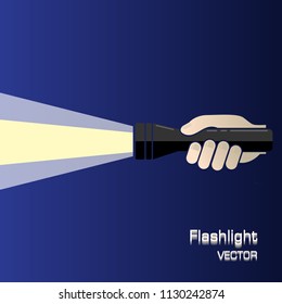 Black flashlight in hand isolated on white beam in blue background