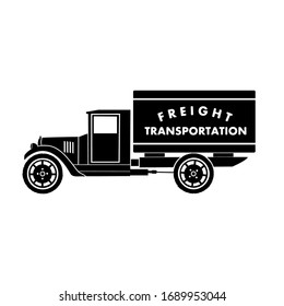 A black flat silhouette of a retro box truck is drawn on a white background. You can see the old box, cab, wheels, hood, cardan shaft and a cabin with a door. Side view. Body with a letter