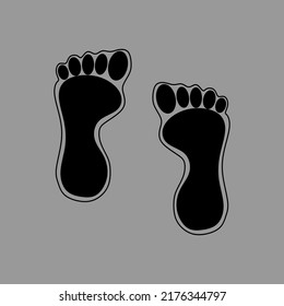 Black foot print on grey background