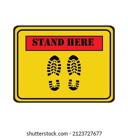 Black footprint and wording  stand here in yellow and red sign. Vector illustration of stand here sign design.