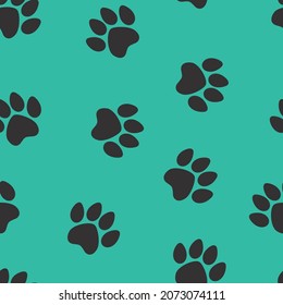 black footprints of a cat on a blue background. seamless abstraction of animal footprints for clothing or print