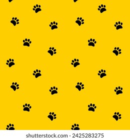 Black footprints paws vector seamless pattern on yellow background. Step, footstep, track background, wallpaper, print, textile, fabric, wrapping paper, packaging design