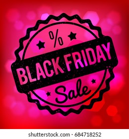 Black Friday rubber stamp black on a pink bokeh background.