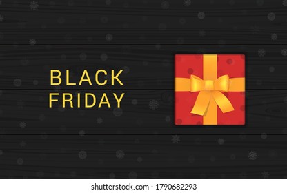 Black friday sale banner design template. Red gift box on a black wooden table. Poster for fall season shopping promotion. Realistic vector illustration