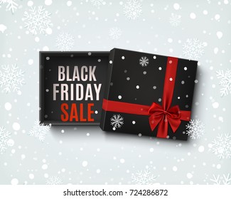 Black Friday sale design. Opened black empty gift box with red ribbon and bow on winter  background with snow and snowflakes. Top view. Template for, banner, brochure or poster. Vector illustration.
