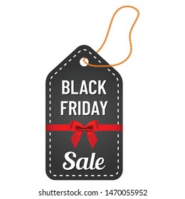 black friday sale white lettering with yellow thread and red ribbon and bow on trendy black tag. black friday commercial illustartion for seasonal promotions and advertising in stores