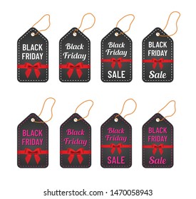 black friday sale white and pink letterings with yellow thread and red ribbon and bow on trendy black tags. black friday commercial illustartion for seasonal promotions and advertising in stores