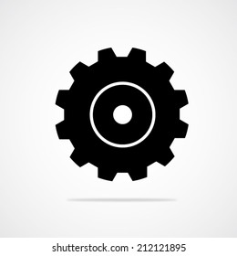 Black gear or cog vector icon with shadow on a white background.