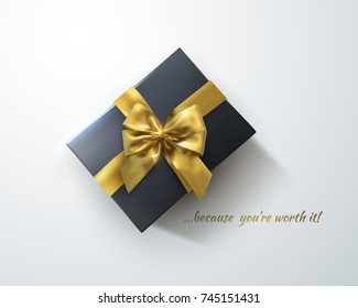 Black gift box with glittering golden bow and crossing ribbons isolated on white background. Vector realistic festive illustration. Decoration element for design. Because you are worth it!