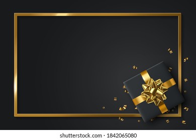 Black gift box and gold bow ribbons with confetti on dark texture background.