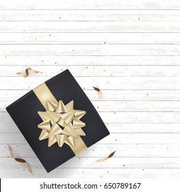 Black gift box and gold bow ribbons with confetti on white wood texture background. Vector illustration