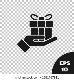 Black Gift box in hand icon isolated on transparent background. Merry Christmas and Happy New Year.  Vector Illustration