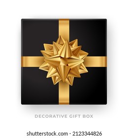 Black gift top view with gold foil paper bow