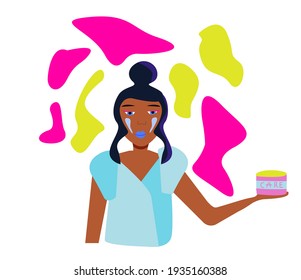 black girl cares for the skin. jar of cream in the hands and on the face.	