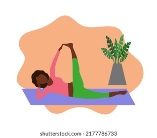 A black girl practices yoga in the Anantasana pose. Sports and health.