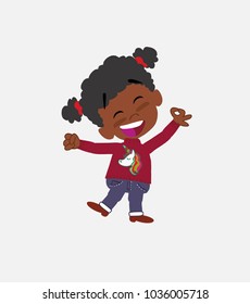 Black girl with a unicorn pullover jumping for joy.