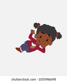Black girl with a unicorn pullover lying, greets with a dreamy expression.