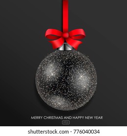 Black glass Christmas ball with Golden glitter on the red ribbon.