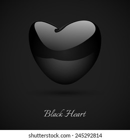 Black glossy heart  on the dark background.