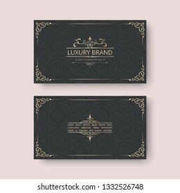 Black and gold foil business cards. Pattern with curls and spiral logo