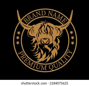 Emblem of  black and gold Highland cattle. Cute head of Scottish cattle isolated on black background. Written Premium Quality. Design element for logo, poster, card, banner, emblem, t shirt. Vector