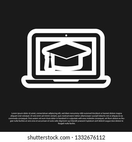 Black Graduation cap on screen laptop icon isolated on black background. Online learning or e-learning concept. Vector Illustration