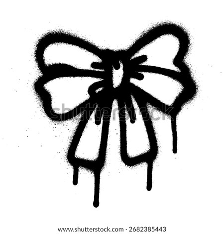 Black graffiti style bow stencil created with spray paint on a white background.