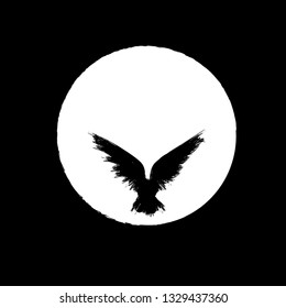 Black grunge bird silhouette with ink splash isolated on white moon