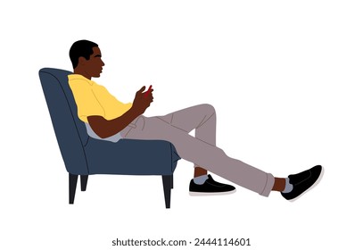 Black Guy sitting in armchair, using smart phone.