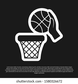 Black Hand with basketball ball and basket icon isolated on black background. Ball in basketball hoop.  Vector Illustration