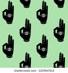 black hand with eye mudra on a green background buddhism hinduism symbol pattern seamless yoga India meditation zen hipster vector.