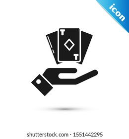 Black Hand holding deck of playing cards icon isolated on white background. Casino gambling.  Vector Illustration