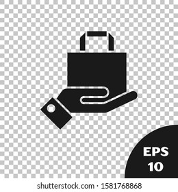 Black Hand and paper shopping bag icon isolated on transparent background. Package sign.  Vector Illustration