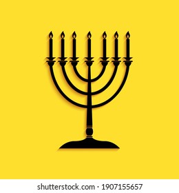 Black Hanukkah menorah icon isolated on yellow background. Religion icon. Hanukkah traditional symbol. Holiday religion, jewish festival of Lights. Long shadow style. Vector.