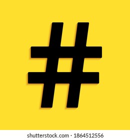 Black Hashtag icon isolated on yellow background. Social media symbol. Modern UI website navigation. Long shadow style. Vector.
