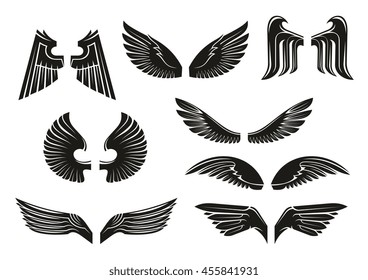 Black heraldic wings set in tribal style for tattoo and book, heraldry or religious design isolated on white. Vintage or retro birds and angel wings