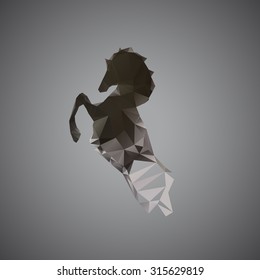 The black horse of polygons. Vector image silhouette of the horse. The horse reared.