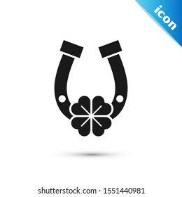 Black Horseshoe with four leaf clover icon isolated on white background. Happy Saint Patricks day.  Vector Illustration