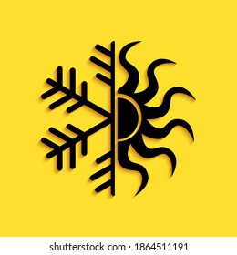 Black Hot and cold symbol. Sun and snowflake icon isolated on yellow background. Winter and summer symbol. Long shadow style. Vector.