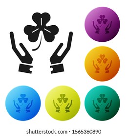 Black Human hands holding four leaf clover icon isolated on white background. Happy Saint Patrick day. Set icons colorful circle buttons. Vector Illustration