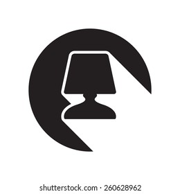 black icon with desk lamp and white stylized shadow