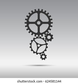 Black icon mechanism from cogwheels in vertically placed isolated on gray background